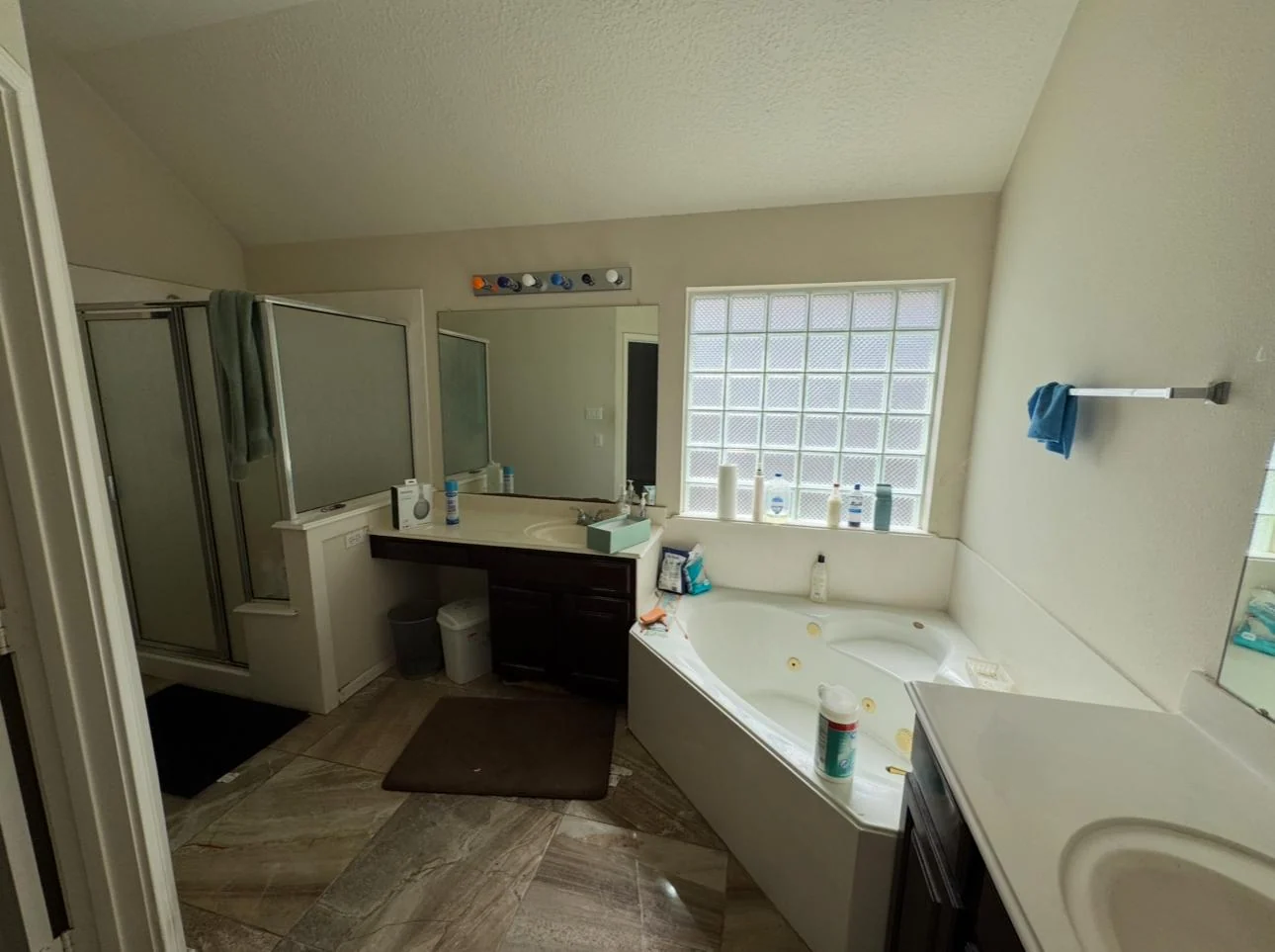 A dated Houston bathroom replaced with a tiled walk-in shower before the remodel