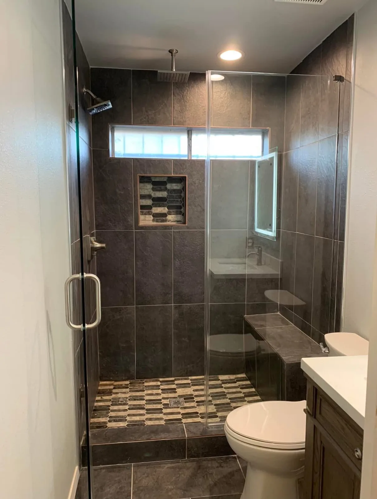 A dated Houston bathroom with the tub converted into a tiled walk in glass shower after the remodel