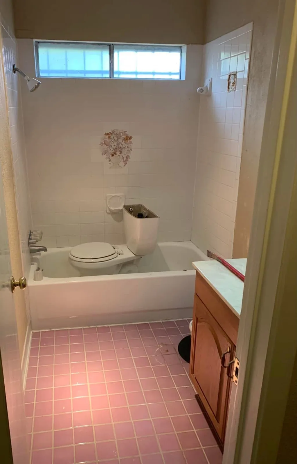 A dated Houston bathroom with the tub converted into a tiled walk in glass shower before the remodel