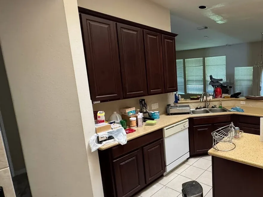 A Houston kitchen rebuilt with a quartz island and new hardwood floors before the remodel