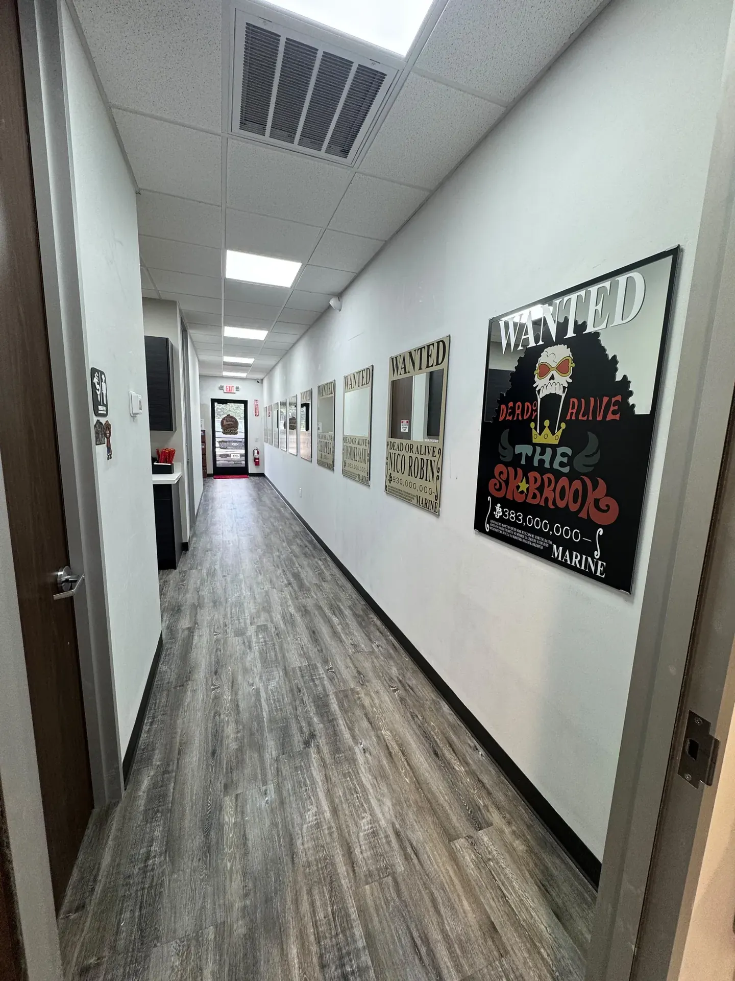 Commercial corridor finished by LL General Contractor with new flooring and lighting
