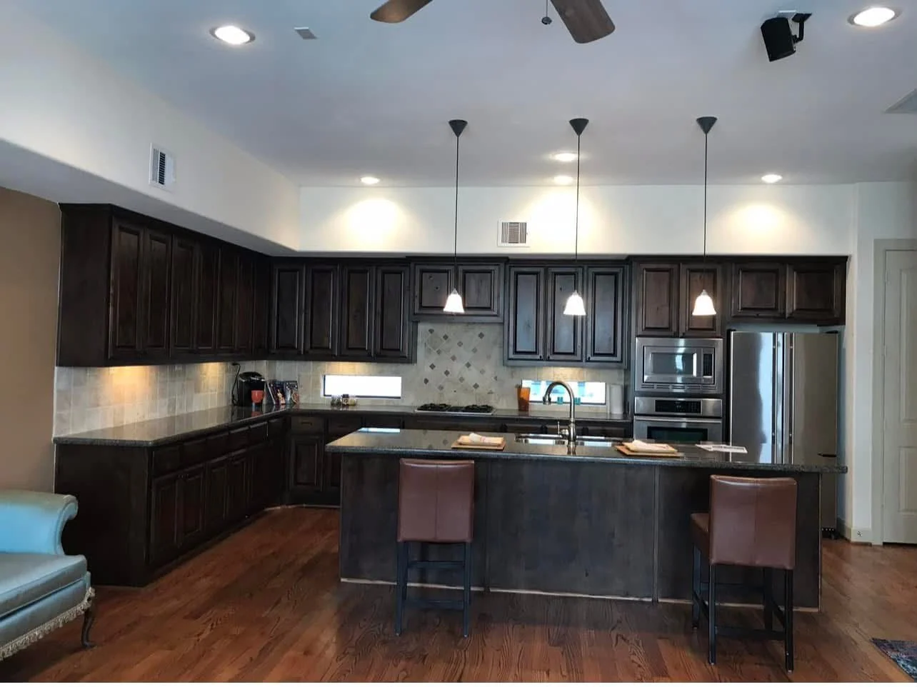 Kitchen remodel by LL General Contractor with a granite island and pendant lighting