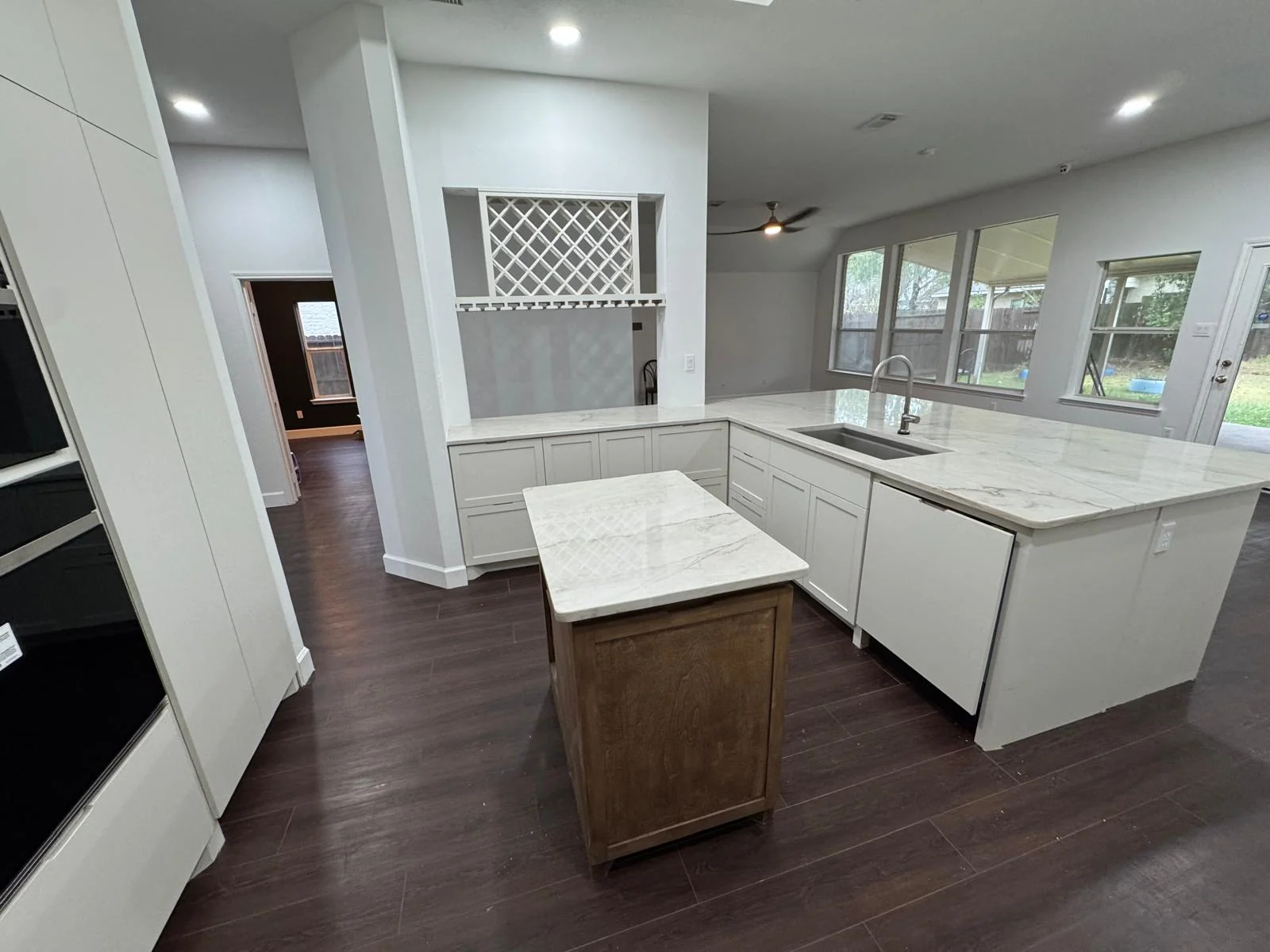 Remodeled kitchen with a quartz island and custom cabinetry by LL General Contractor