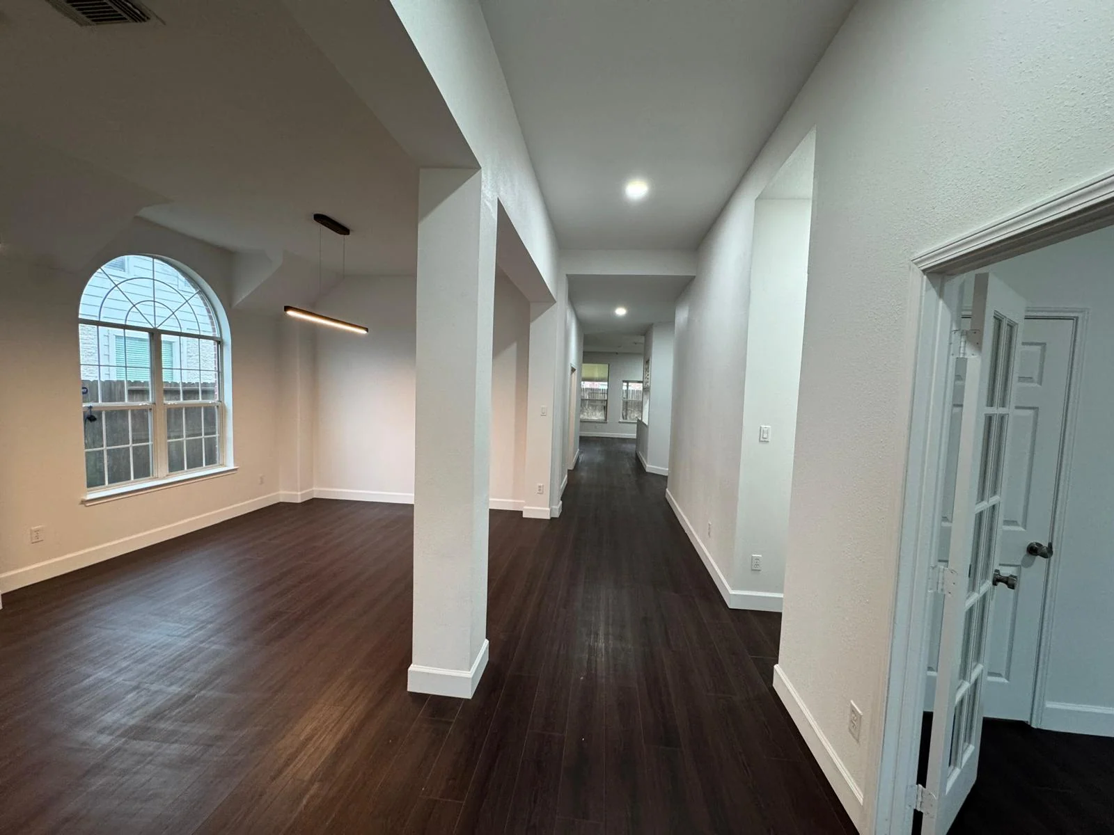 Interior remodel by LL General Contractor with columns and dark hardwood floors