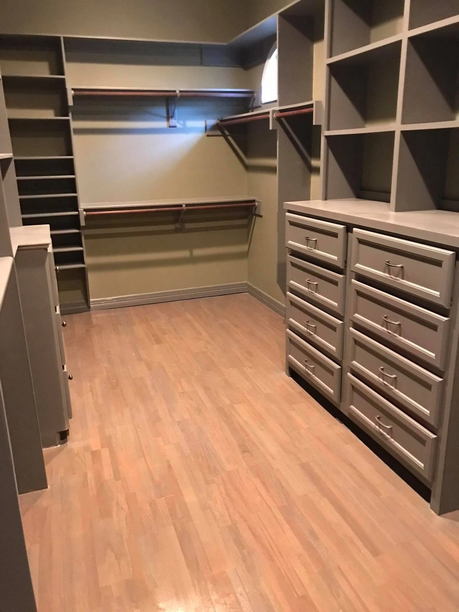 Walk-in closet built by LL General Contractor with fitted drawers and hanging space