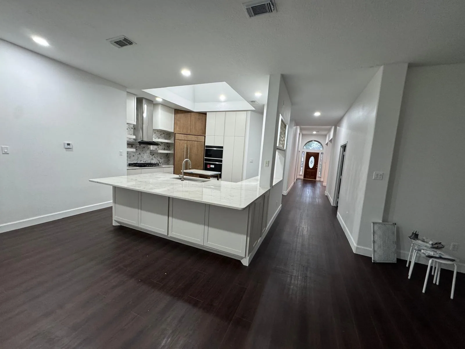 Flat finished ceiling above a remodeled kitchen and hallway by LL General Contractor